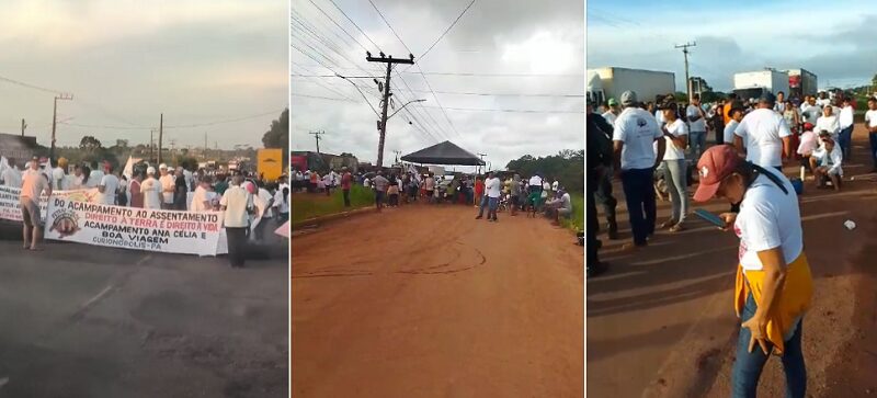 Multidão de pessoas em protesto por direitos à terra e moradia em Curionópolis, carregando um banner grande.