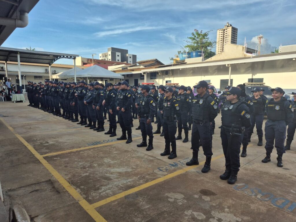 Grupo de policiais militares em formação no pátio.