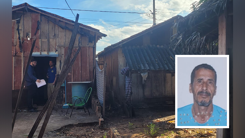 Homens em frente a casas de madeira simples com foto de um homem em destaque.