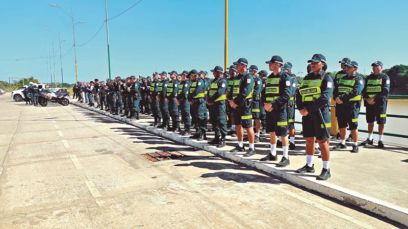 Linha de policiais militares brasileiros em formação de prontidão ao ar livre