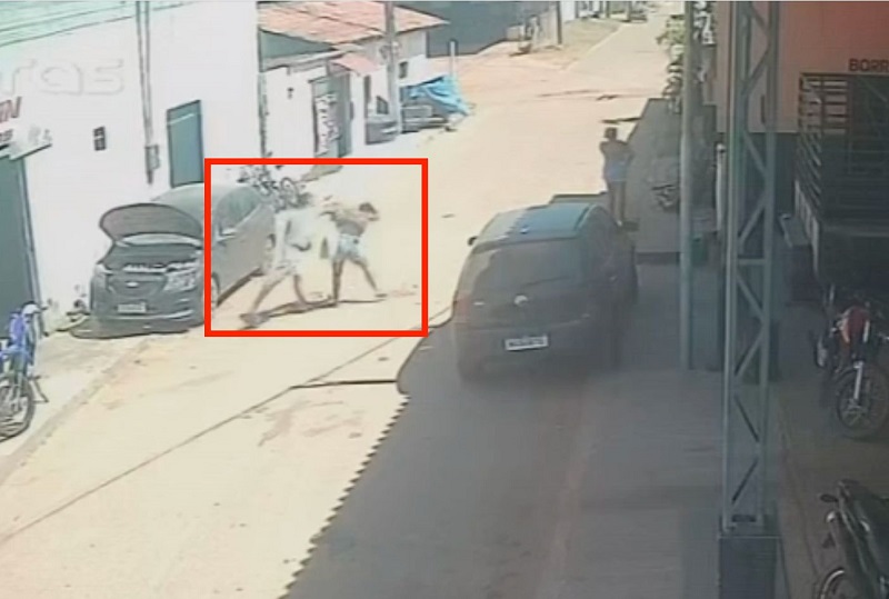 Câmera de segurança mostra duas pessoas em um possível conflito físico na rua
