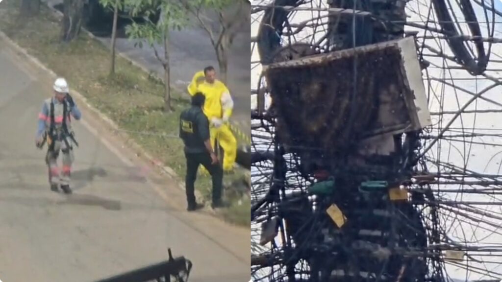 Profissional com roupa de proteção amarela ao lado de um veículo acidentado carbonizado