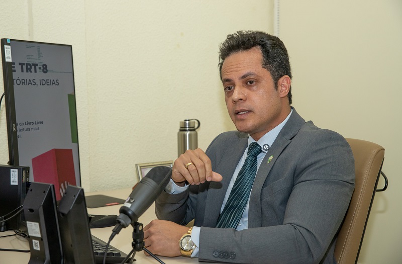 Homem de terno gravata falando em um microfone